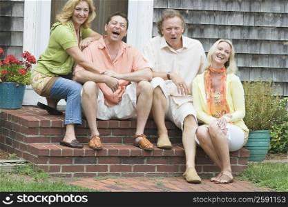 Two couples sitting together and laughing