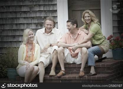 Two couples sitting together and smiling