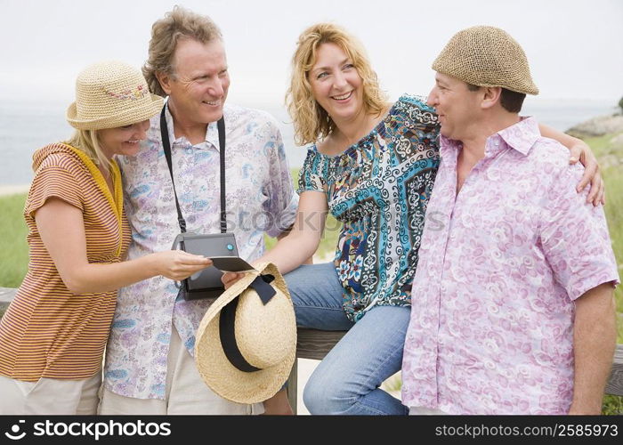 Two couples smiling in a park