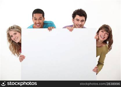 Two couples stood with advertising board