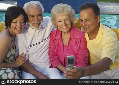 Two couples taking self portrait with mobile phone