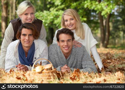 Two couples with a basket of mushrooms