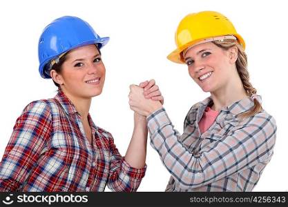 two craftswomen arm wrestling