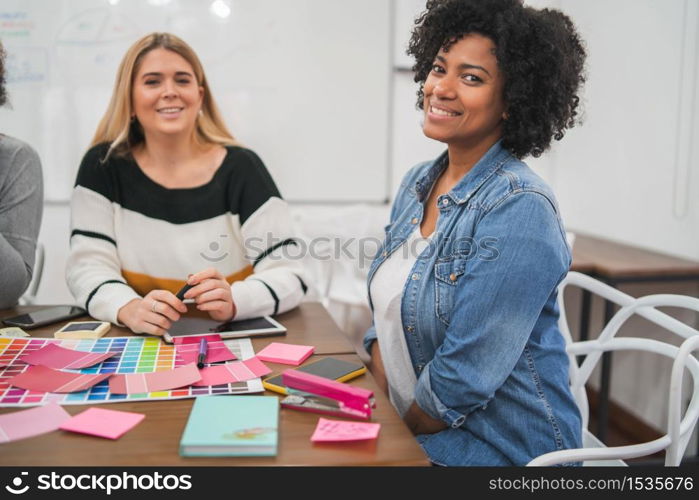 Two creative women partners discussing ideas by workplace. Business and teamwork concept.