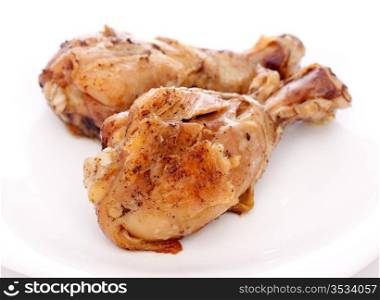 two crispy fried chicken legs on a white dish