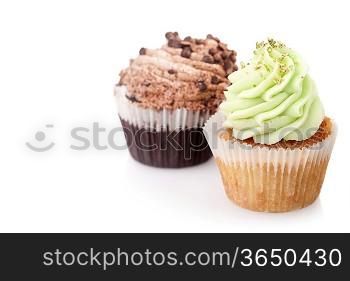 two cupcakes with cream isolated on white background with copyspace