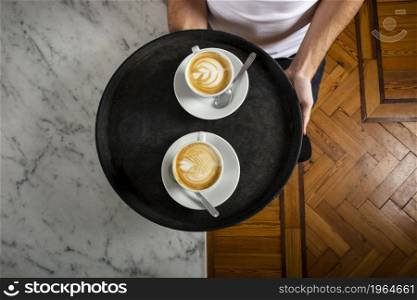two cups coffee with latte art tray. High resolution photo. two cups coffee with latte art tray. High quality photo