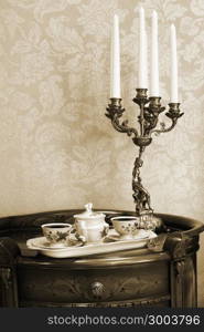 two cups of coffee and antique brass candlestick