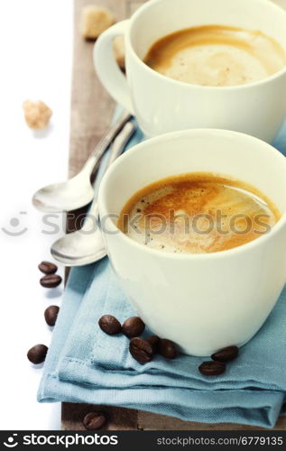 two cups of coffee with blue napkin