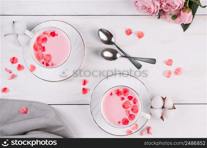 Two cups of pink matcha. Trendy vegan tea on a white background. Relaxing drink recipe for sleepy times.. Two cups of pink matcha. Trendy vegan tea on white background. Relaxing drink recipe for sleepy times.