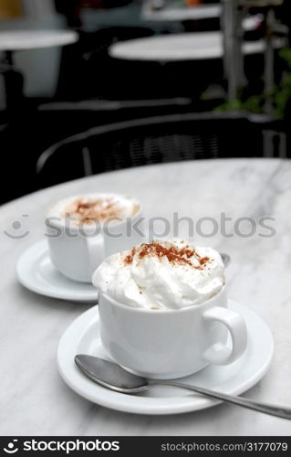 Two cups of specialty coffee on a table in a cafe