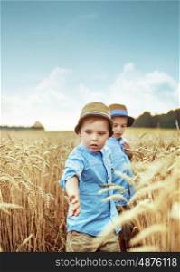 Two cute brothers in the wheat field