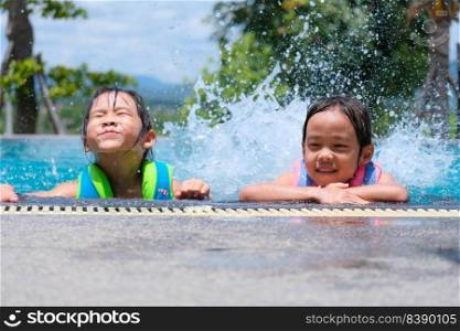 Two cute little girls playing in the pool. Summer lifestyle concept.