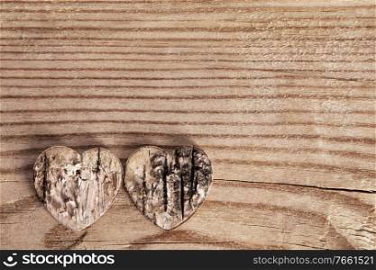 Two damaged rough rotten hearts on wooden background with copy space , love, Valentines day card. Damaged hearts love concept