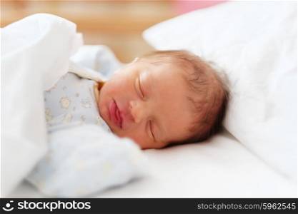 Two days old newborn baby in bed
