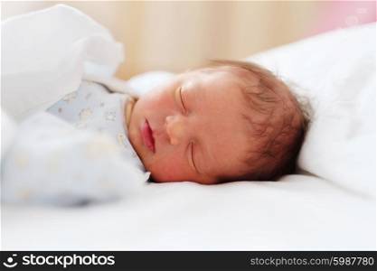 Two days old newborn baby in bed