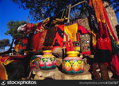 Two decorated pots and clothing at a market stall, Jodhpur, Rajasthan, India