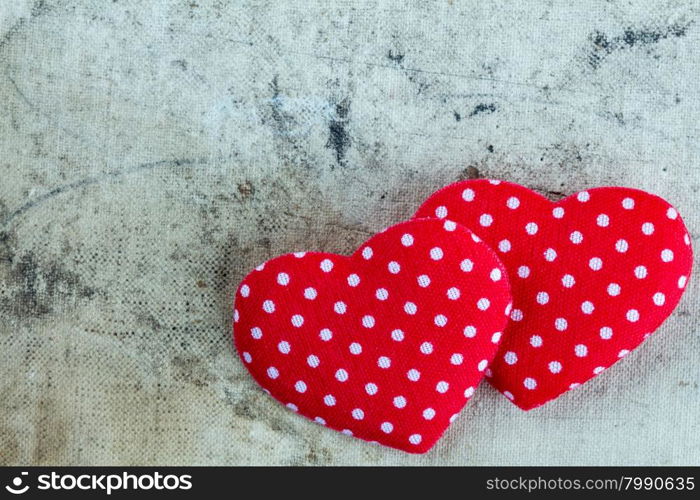 Two decorative hearts on dirty canvas background
