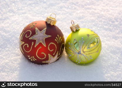 Two decorative spheres on a white snow.