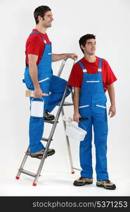 Two decorators stood by ladder