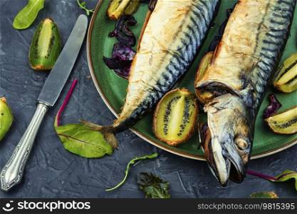 Two delicious scomber fish baked with kiwi pieces.. Grilled mackerel fish with kiwi