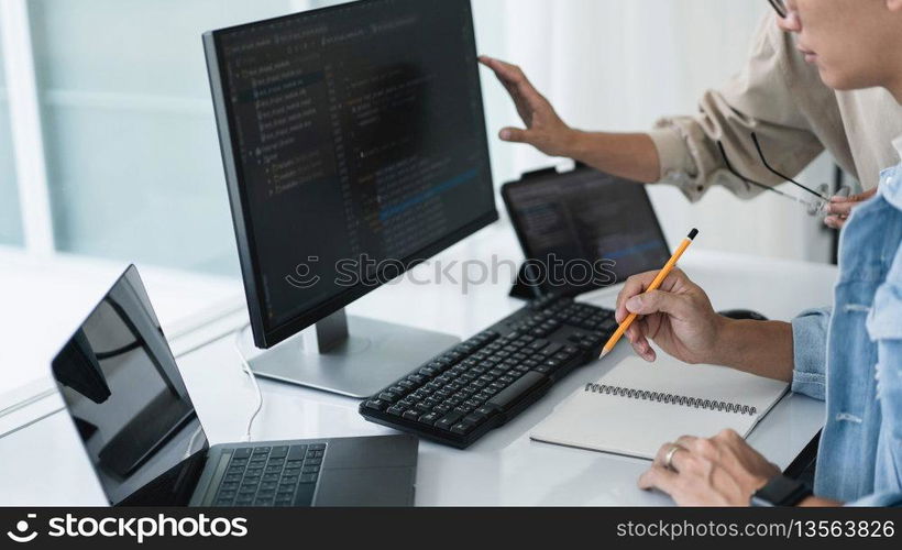 Two developer programmer checking code and writing note while programming to developing web and app.