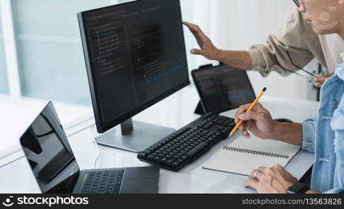 Two developer programmer checking code and writing note while programming to developing web and app.