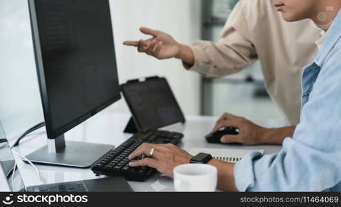 Two developer programmer discussing and typing code on keyboard for programming to developing web.