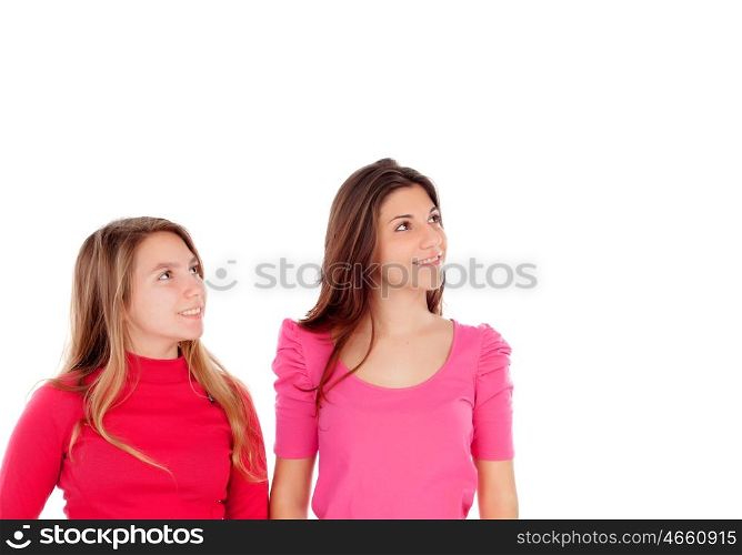 Two different sisters looking up isolated on a white background