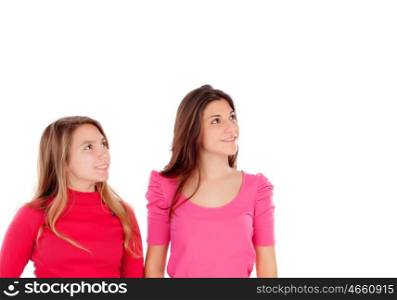Two different sisters looking up isolated on a white background