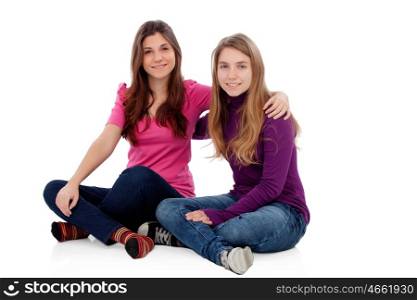 Two different sisters sitting on the floor isolated on a white background