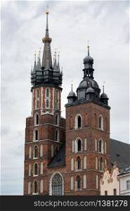 Two different towers of St Mary&rsquo;s Church, Kosciol Mariacki, at the main Market Square, Rynek, in Cracow, Poland. Towers St Mary&rsquo;s Church at Market Square in Cracow, Poland