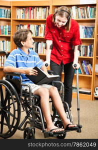 Two disabled kids in the school library, one in a wheelchair and one with crutches.