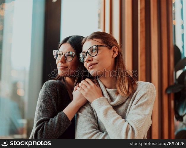 Two diverse girls lesbian couple hugging looking at camera, close up portrait. Stylish cool generation z women dating in love enjoy romantic relationships. Lgbtq concept. . Diverse girls lesbian couple hugging. Stylish cool generation z women dating in love enjoy romantic relationships i