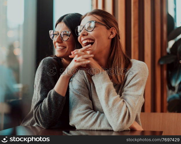 Two diverse girls lesbian couple hugging looking at camera, close up portrait. Stylish cool generation z women dating in love enjoy romantic relationships. Lgbtq concept. . Diverse girls lesbian couple hugging. Stylish cool generation z women dating in love enjoy romantic relationships i