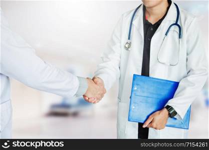 Two Doctor is handshake work in the hospital.