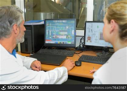 two doctors analyzing mri xrays on computer