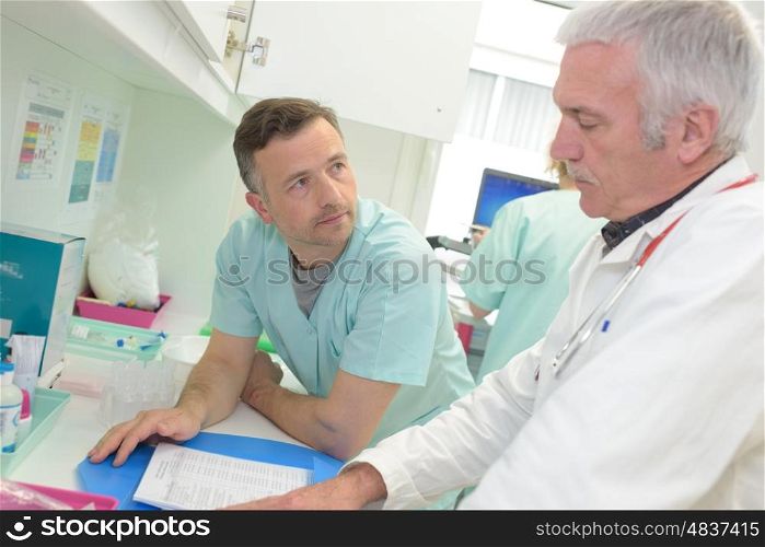 two doctors at hospital with clipboard