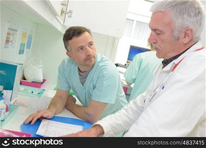 two doctors at hospital with clipboard