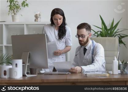 Two doctors discussing test results and working together