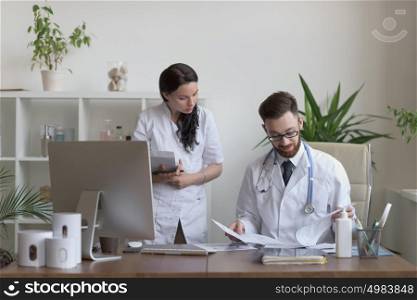 Two doctors discussing test results and working together
