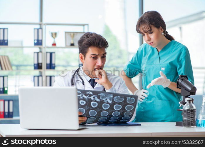 Two doctors discussing x-ray MRI image in hospital