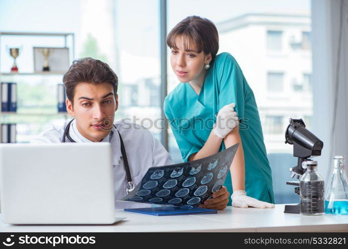 Two doctors discussing x-ray MRI image in hospital