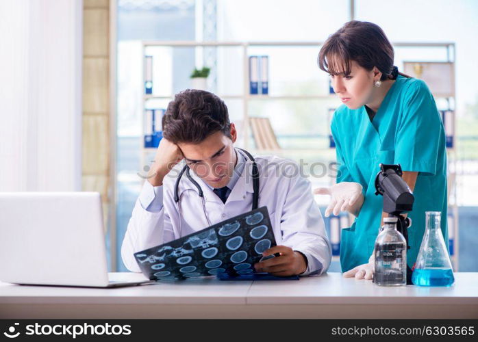 Two doctors discussing x-ray MRI image in hospital