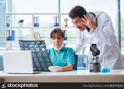 Two doctors discussing x-ray MRI image in hospital