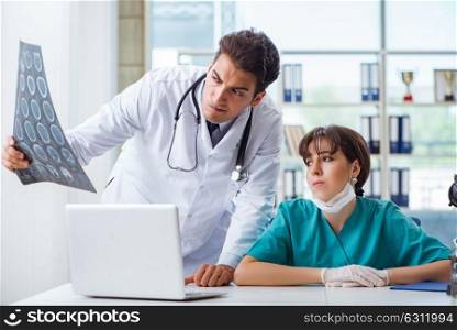 Two doctors discussing x-ray MRI image in hospital. The two doctors discussing x-ray mri image in hospital