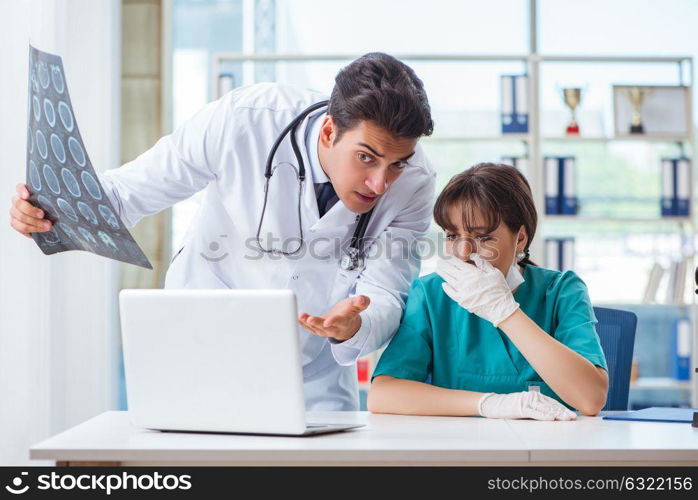 Two doctors discussing x-ray MRI image in hospital