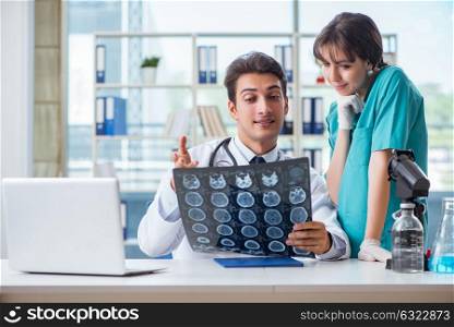 Two doctors discussing x-ray MRI image in hospital