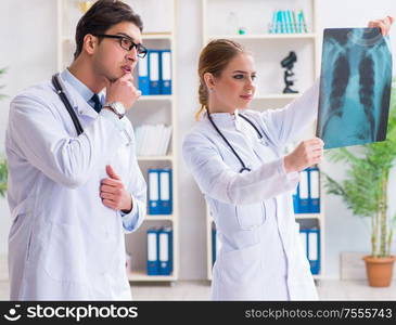 Two doctors examining x-ray images of patient for diagnosis. The two doctors examining x-ray images of patient for diagnosis