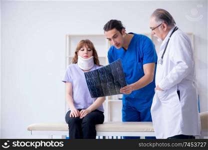 Two doctors examining young woman 
